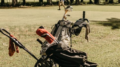 Golf bag and course view for booking a round in Japan